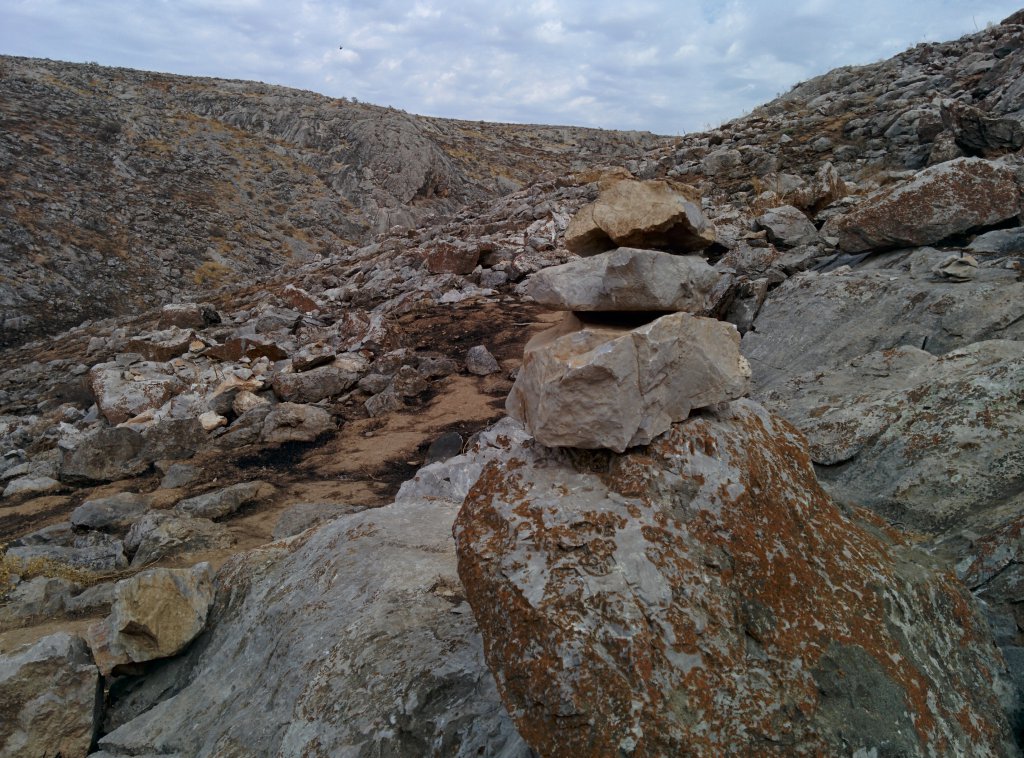 Info Shymkent - A rough limestone landscape around the cave.