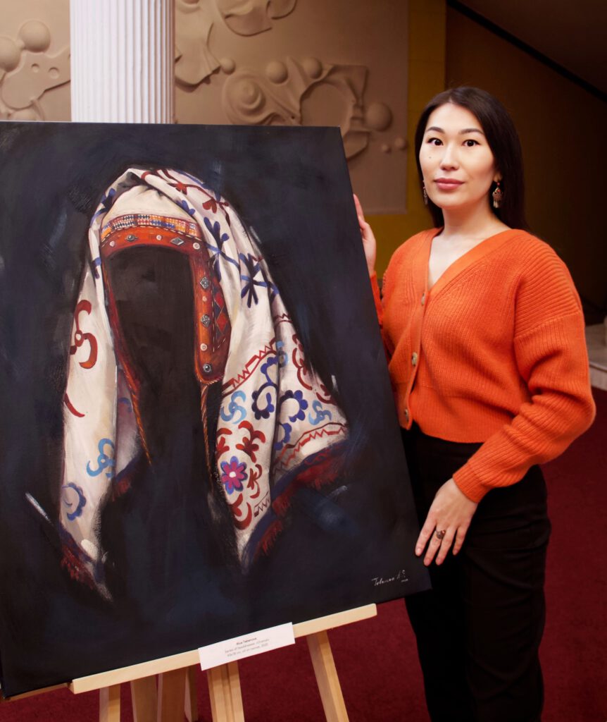 Info Shymkent - Kazakh Artist Alua Tebenova standing next to one of her painting