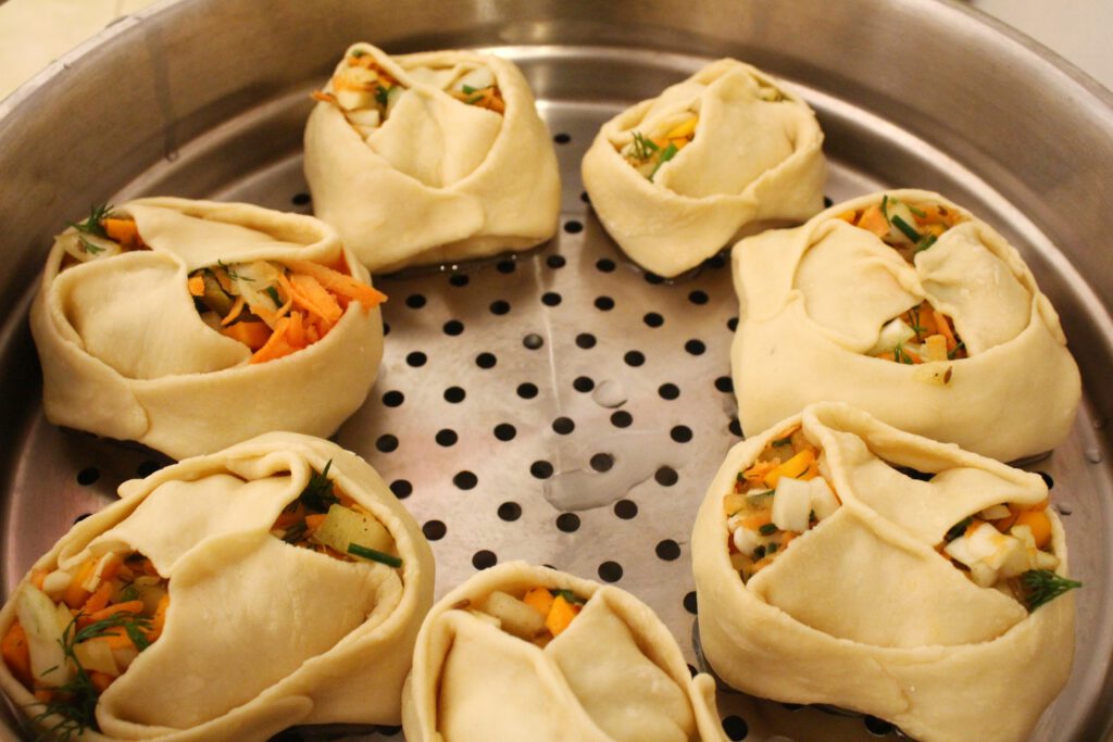 Preparing the dumplings to steam in the Manti cooker