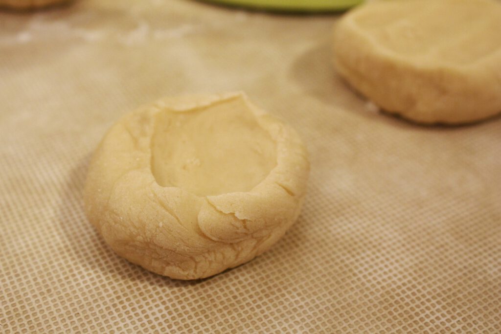 Cutting the dough in pieces to make the dumplings of Manti