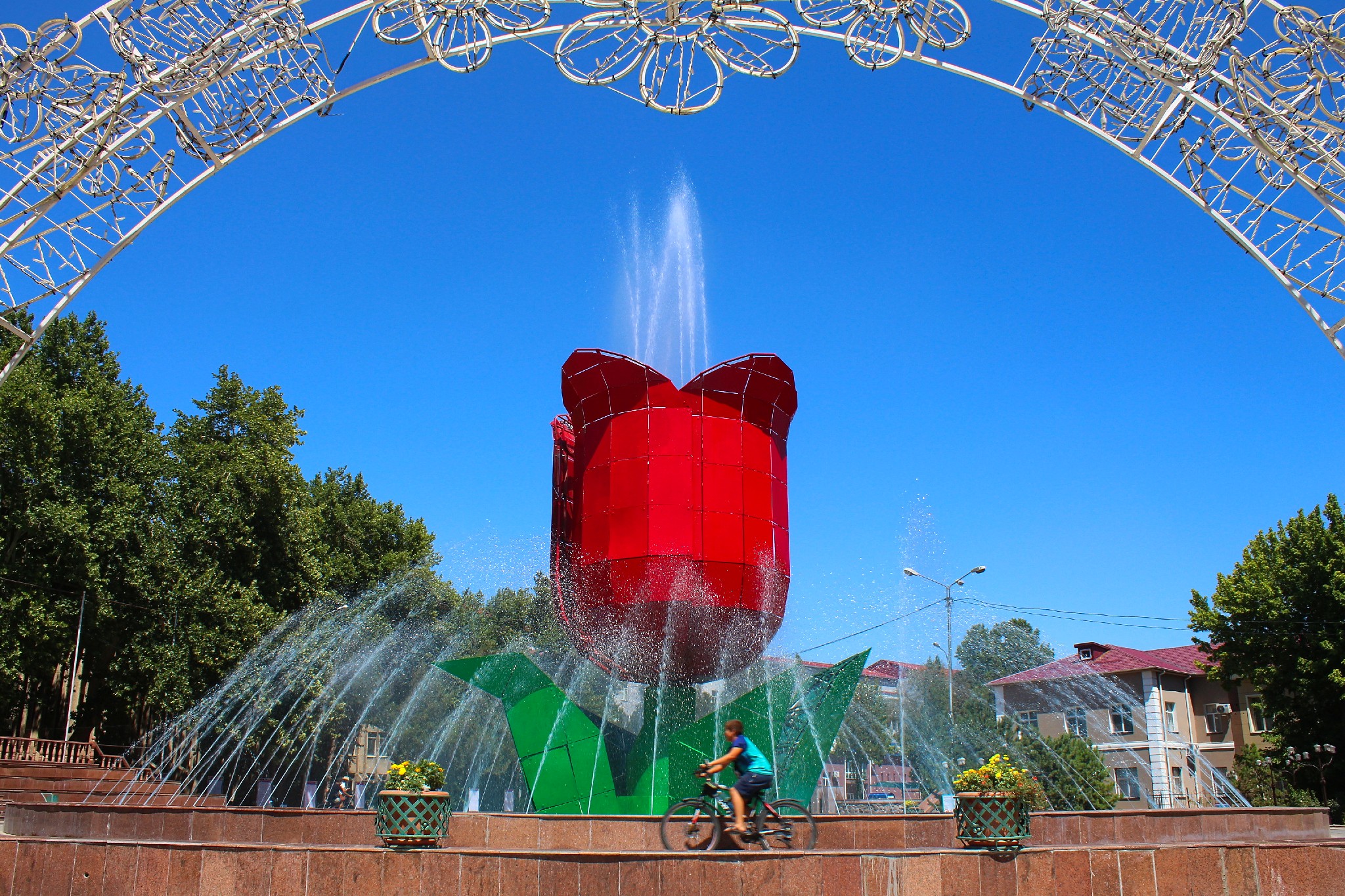 Info Shymkent - A Boy is Cycling around Tulip Fountain in Shymkent, Kazakhstan